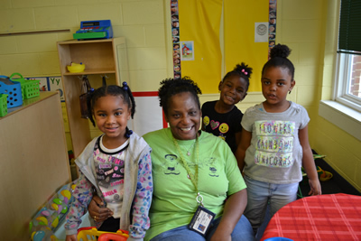 Some children posing with their teacher.