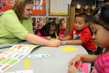Photo of teacher working with several students