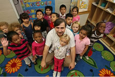Photo of Director Benatti surrounded by a group of students