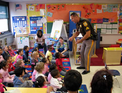 Police officer speaking to a group of Head Start students